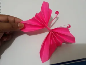 A Delicate Butterfly Origami Sculpture Perched Against A White Background. Wallpaper