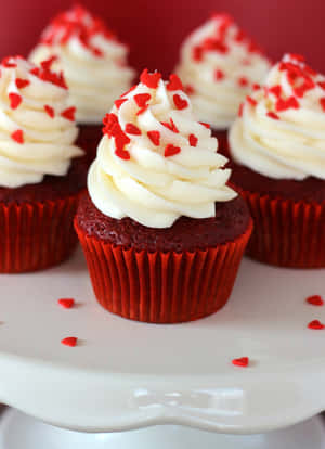 A Delicious Slice Of Red Velvet Cake Served With Fresh Raspberries Wallpaper