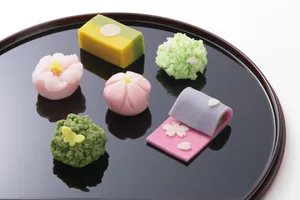 A Delightful Variety Of Colorful Japanese Sweets Served On Elegant Dishes. Wallpaper