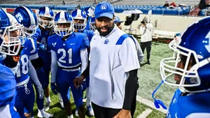 A Determined Football Coach Strategizing Play Wallpaper