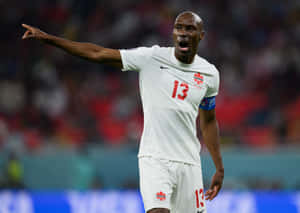 A Determined Soccer Captain Leading The Team On The Field. Wallpaper