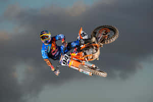 A Dirt Bike Rider In The Air Wallpaper