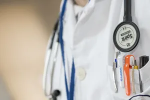 A Doctor's Coat With A Stethoscope And A Pen Wallpaper