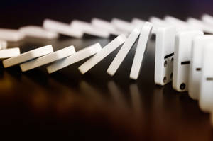 A Dynamic Display Of Falling Dominoes Wallpaper