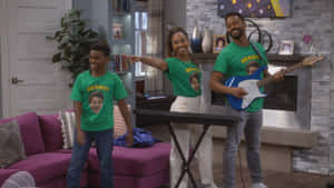 A Family In A Living Room With A Guitar And T - Shirts Wallpaper