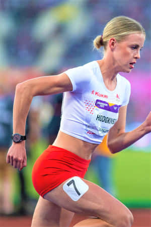 A Female Athlete Running On A Track Wallpaper