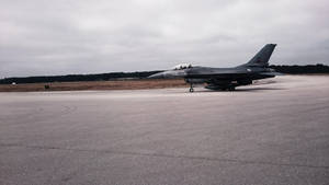 A Fighter Plane Flying Through The Sky Wallpaper