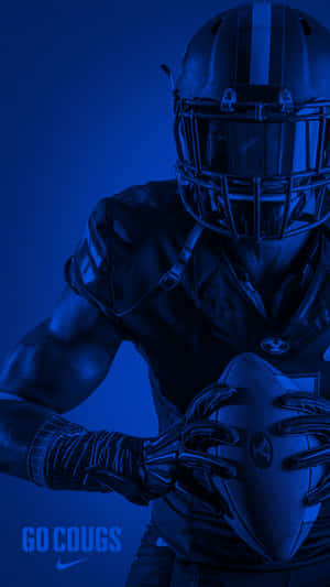 A Football Player Holding A Ball Wallpaper