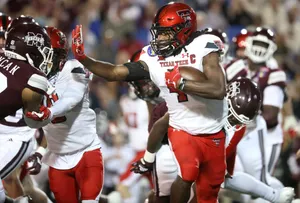 A Football Player Running With The Ball Wallpaper