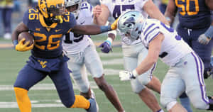 A Football Player Running With The Ball Wallpaper