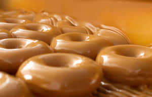 A Freshly Made Glazed Donut Ready For Your Breakfast Or Snack. Wallpaper