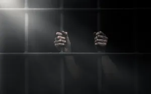 A Gavel On A Wooden Surface Representing Mandatory Prison Sentence Wallpaper