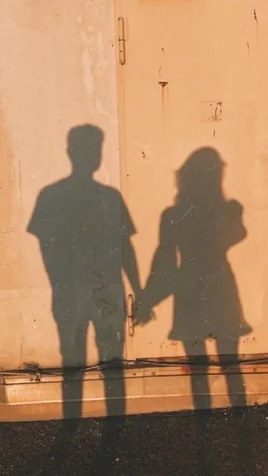 A Girl And Boy Shadow On The Wall Wallpaper