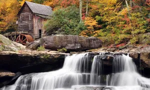 A Girl Dressed In Warm Winter Wear Enjoys Herself Atop A Snow Covered Hill Wallpaper