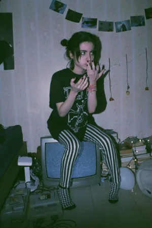 A Girl In A Room With A Tv And A Cigarette Wallpaper