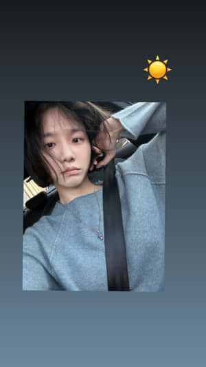 A Girl Is Sitting In A Car With Her Phone Wallpaper