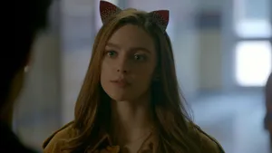 A Girl Wearing Cat Ears Is Looking At Someone Wallpaper
