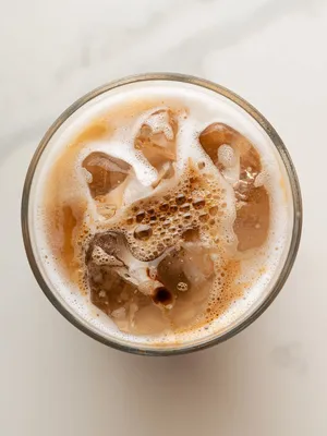 A Glass Of Coffee With Ice And Ice Cream Wallpaper