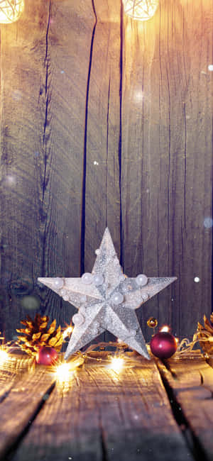 A Glistening Christmas Star Lighting The Way Wallpaper