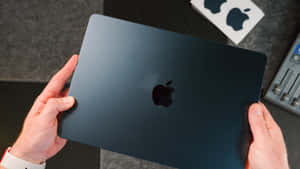 A Glossy Black Macbook Pro With Retina Display Wallpaper