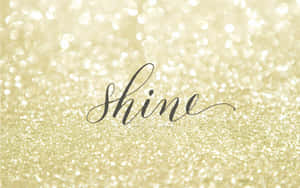 A Gold Glitter Background With The Word Shine Wallpaper