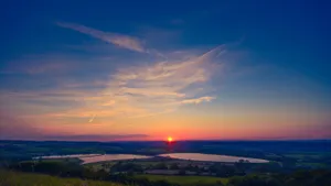 A Golden Sky Filled With Cirrus Clouds During A Sunset Wallpaper