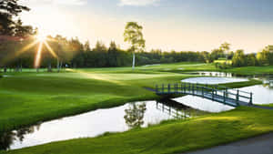 A Golf Course With A Bridge And Water Wallpaper