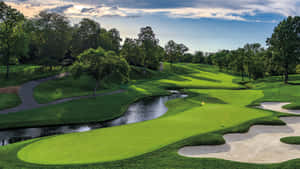 A Golf Course With A Stream And Trees Wallpaper