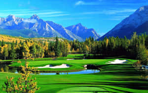 A Golf Course With Mountains In The Background Wallpaper