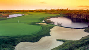 A Golfer Focuses On Teeing Off In A Golf Course Wallpaper