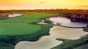 A Golfer Focuses On Teeing Off In A Golf Course Wallpaper