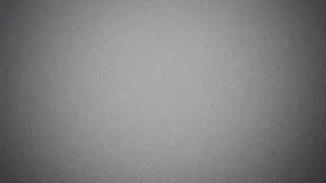 A Gray Background With A White Airplane Flying Over It Wallpaper