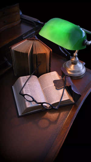 A Green Lamp On A Desk Wallpaper