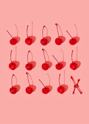 A Group Of Cherries On A Pink Background Wallpaper