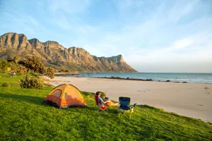 A Group Of Friends Enjoying A Beach Camping Adventure Wallpaper