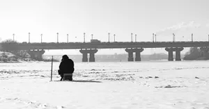 A Group Of Friends Enjoying Ice Fishing On A Frozen Lake Wallpaper
