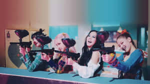 A Group Of Girls With Paint Guns In A Room Wallpaper