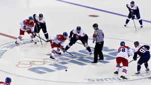 A Group Of Hockey Players On The Ice Wallpaper