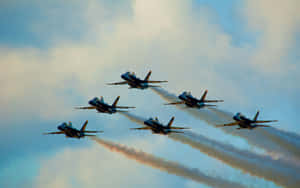 A Group Of Jets Flying In The Sky Wallpaper