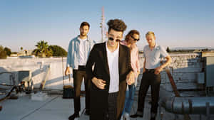 A Group Of Men Standing On A Roof Wallpaper