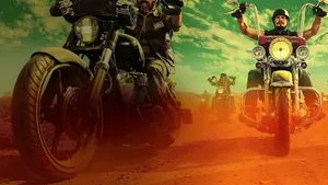 A Group Of Motorcycle Riders On A Dirt Road Wallpaper