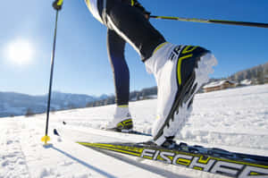 A Group Of People Enjoying Skiing Activities At A Snowy Mountain Resort Wallpaper