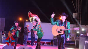 A Group Of People On Stage With Guitars Wallpaper