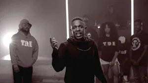 A Group Of People Standing In Front Of A Light Wallpaper