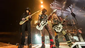 A Group Of People Standing On Stage With Guitars Wallpaper