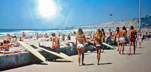 A Group Of People Walking Along The Beach Wallpaper