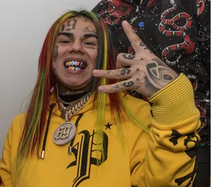 A Group Of People With Tattoos And A Sign Wallpaper