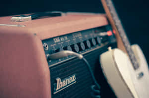 A Guitar Amplifier With A Guitar On It Wallpaper