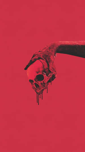 A Hand Reaching Out To A Skull On A Red Background Wallpaper