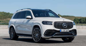 A Happy Family Ready For A Road Trip In Their Stylish Car Wallpaper